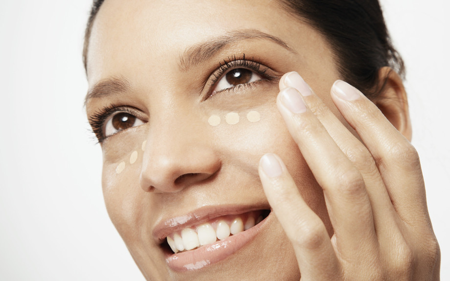 Woman applying concealer